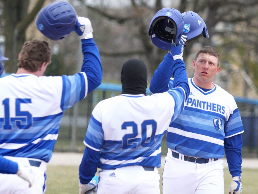 Senior Matt Albert is congragulated at the plate by redshirt junoir Tyler Tesmond (15) and senior Logan Beaman after hitting a three-run home run in the fourth inning in Eastern’s 10-8 loss to Indiana State Tuesday at Coaches Stadium. Albert has three home runs this season.
