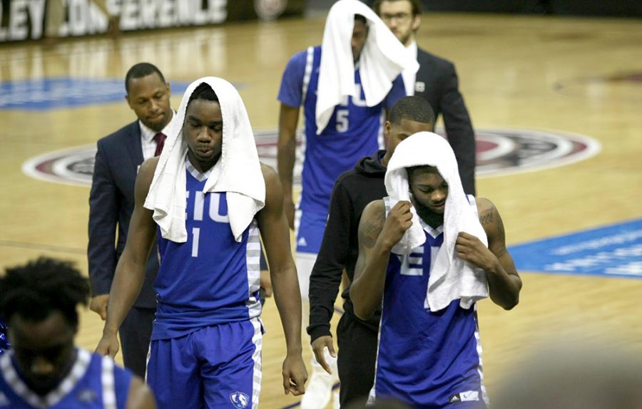 Eastern seniors Montell Goodwin, bottom right, and teammate Ray Crossland (5) exit the floor for the last time after a 73-66 loss to Austin Peay. The two seniors combined for 25 points, 7 rebounds and 3 steals in the 2nd round loss.