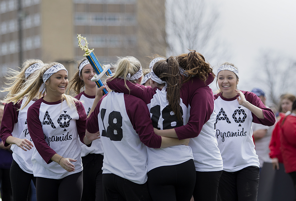 Members of Alpha Phi celebrate after winning first place for Pyramids on Saturday near the campus pond. Pyramids was one of the events featured in Greek Week.