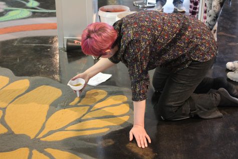 Jessica Mertz creates sand art inside of the Doudna Fine Arts Center on Saturday afternoon during Celebration.