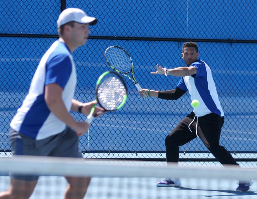 Senior Jared Woodson returns a ball on his forehand during doubles. Woodson and his partner, sophomore Gage Kingsmith (left) have found success this season as a doubles team.
