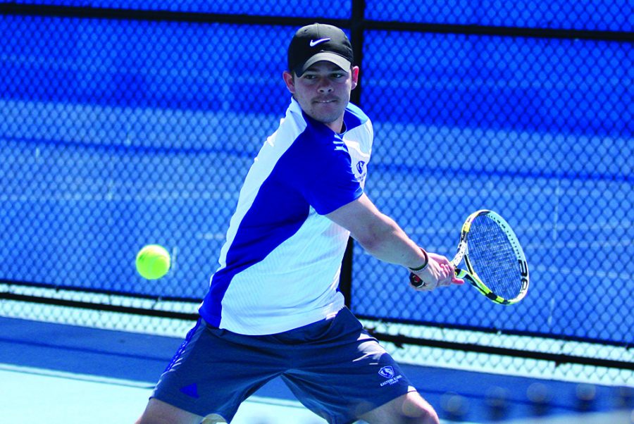 Senior Grant Reiman sends a back hander to his Belmont doubles opponents Friday at the Darling Courts. Reiman and partner Logan Charbonneau lost 7-5 to Belmont as Eastern lost 7-0 overall. The Panthers picked up a win Saturday against Tennessee State.