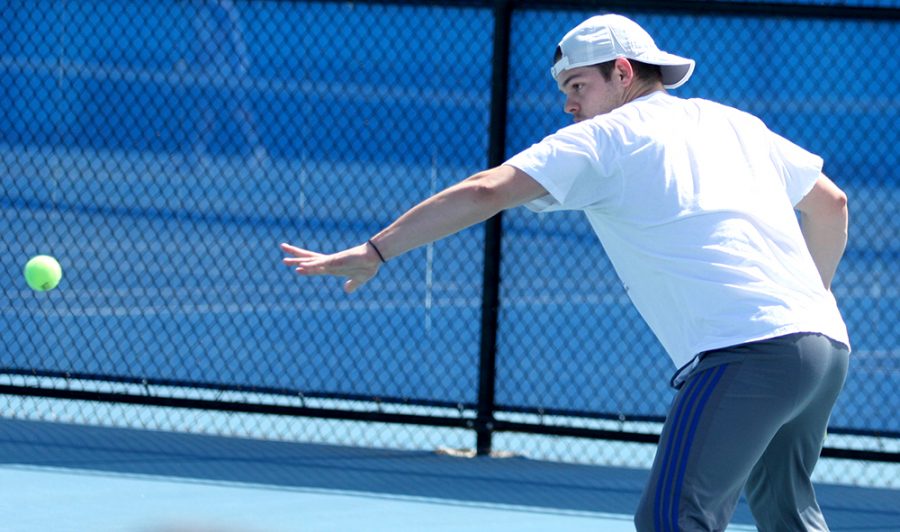 Senior Trent Reiman sends a forehand over the net in his singles match against Belmont March 30 at the Darling Courts. Eastern starts the OVC Tournament later this week.