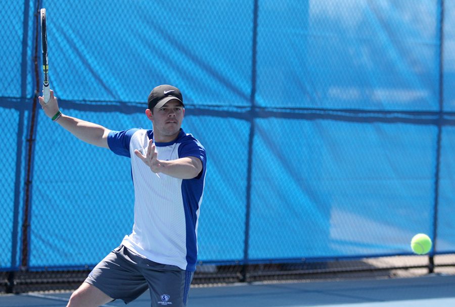Senior Grant Reiman returns the ball on his forehand in Eastern’s match against Belmont March 30 at the Darling Courts. Despite a first-round OVC Tournament loss, Eastern improved overall and has the team excited for the future.