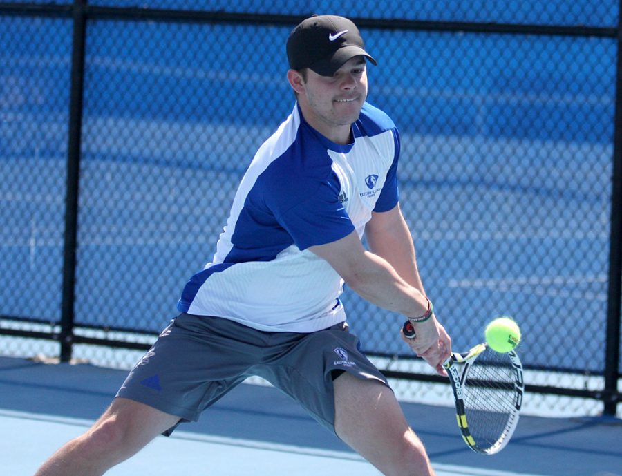 Senior+Grant+Reiman+returns+a+backhand+in+his+match+against+Belmont+March+30+at+the+Darling+Courts.+Eastern+won+its+Senior+Day+match+against+Marian+Saturday.