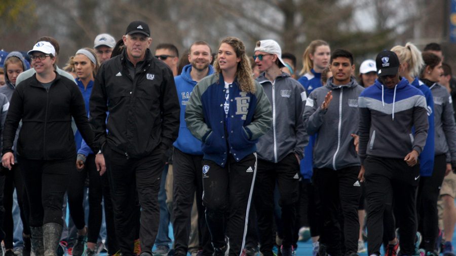 Eastern track and field coach Tom Akers leads the honorary walk around the track for his last home meet as coach Friday at O’Brien Field. The women’s track team placed third and the men’s team finished second in the EIU Big Blue Classic.