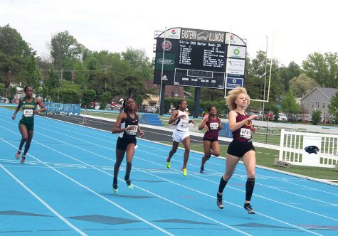 Participants race down the track during the 100-meter dash Thursday.