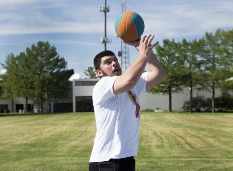Alex Lang, a senior public relations major, plays basketball Wednesday afternoon outside of Andrews Hall. Lang said, while it is empty in Charleston over the summer, he enjoys some time to himself.
