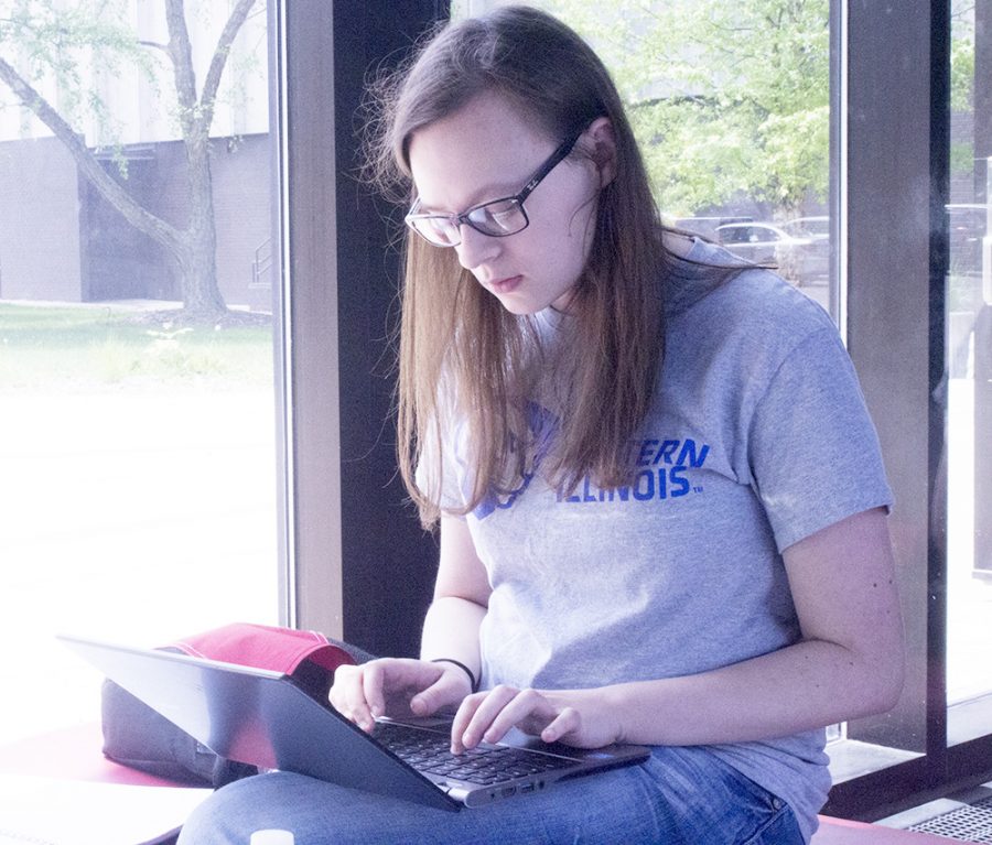 Emma Roark, a senior mass communications major, studies in the sun in a quiet area of the Doudna Fine Arts Center. Roark decided to take summer classes so that she could graduate next spring. “I don’t want a heavy class schedule. That would be awful,” Roark said.