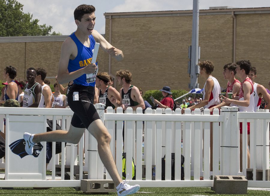 Dylan Jacobs, a senior from Sandburg High School, crosses the finish line and celebrates after realizing he placed first during the Class 3A 4x800-meter relay Saturday at O’Brien Field. Jacobs was competing at the Illinois High School Association Boys Track and Field State Finals.