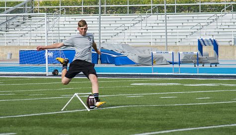 Connor Woodley, a Charleston resident, practices football at O'brien Field Monday afternoon.