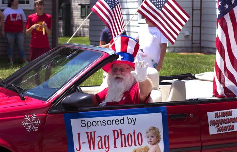 The Illinois Professional Santa, drives down division street, Wednesday afternoon at the Fourth of July Parade.