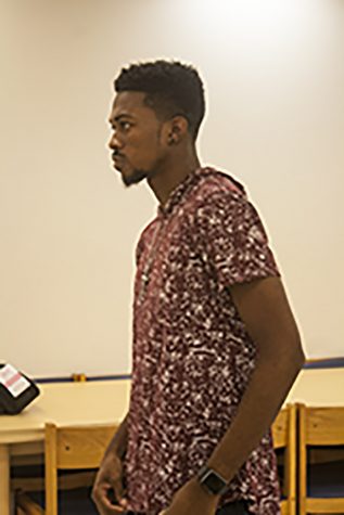 Danovan Gatling, a senior majoring in environmental biology. Gatling was showing a demonstration on how to walk and pose.
