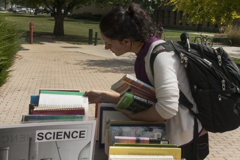 Emily Oberg, a junior double majoring in philosophy and political science, looks around at the book sale outside of Booth Library on Wednesday.