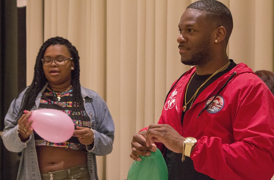 David Hagler (right), a junior business management major, helps Jessica Jimerson, a senior kinesiology and sports studies major, blow up balloons Saturday night for a 90s-themed dance in the University Ballroom of the Martin Luther King Jr. University Union. The dance was hosted by the National Association of Colored Women’s Clubs.