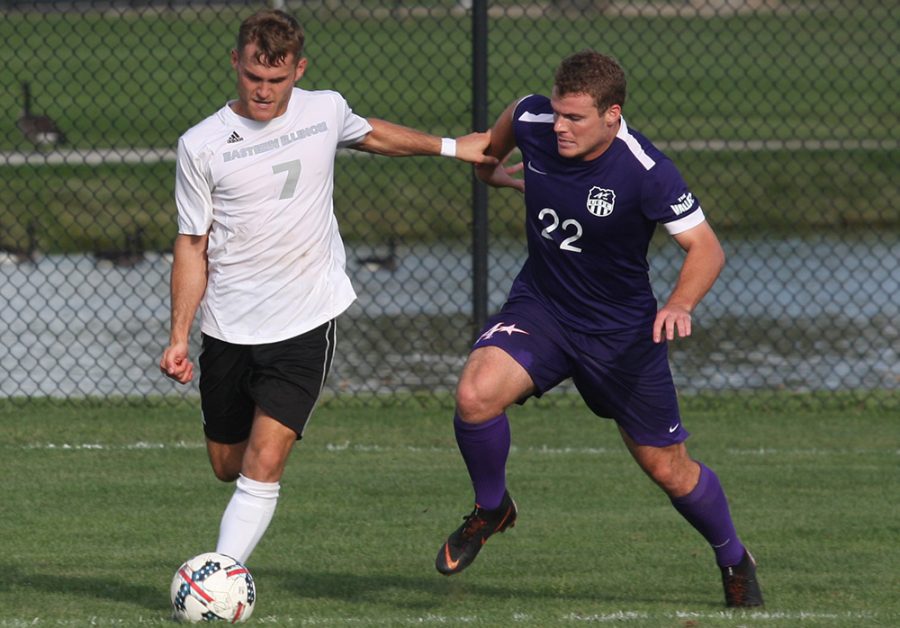 Eastern senior midfielder Jake Andrews holds off an Evasnville defender as he gets ready to cross the ball into the box. Eastern drew 1-1 with Evansville at Lakeside Field on Aug. 31.