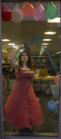 Miranda Smith, a junior math and history double major, paints a mountain to replicate those in the movie “UP” Sunday night in Thomas Hall for the ROCFest window painting competition. The theme for ROCFest is “Panthers go to Hollywood,” and residents from Thomas Hall are painting scenes from “Up.” The windows will be judged at 8 a.m. Thursday.