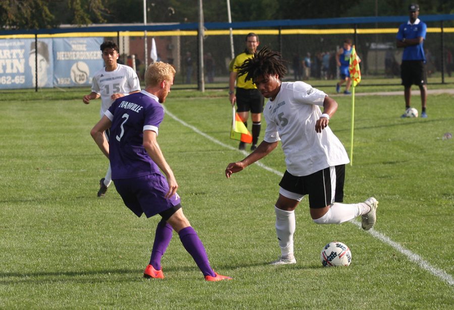 Freshman Cole Stephens tries to do a move with the ball to get around an Evansville defender during Eastern’s 1-1 draw with Evansville at Lakeside Field on Aug. 31.