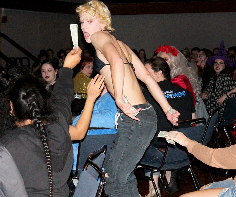 Cherry Bottom, a performer in the EIU Pride Student Drag Show, takes tips from audience members Tuesday night in the Grand Ballroom at the Martin Luther King Jr. University Union. Performers were tipped by the audience throughout their performances.