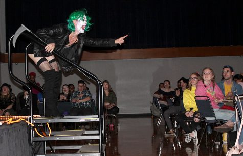 Mother Natwhore, a performer in the student drag show and co-host for the event, laughs as a part of his performance Tuesday night in the Grand Ballroom. He “died” during the show and came back to life for a second and third performance.