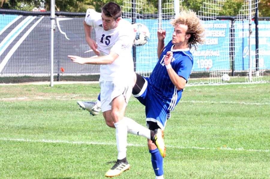 Eastern redhsirt-freshman Cameron Behm fights for a ball with a Western Illinois defender on Oct. 6 at Lakeside Field. The men’s soccer team is 3-6-3 this season, they play Valparaiso Wednesday at Lakeside Field.