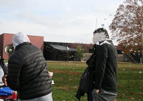 Teriq Phillips, a freshman business management major, throws a pie at Matthew Wright, the director of football operations, Thursday afternoon at Pie a Celeb in the Library Quad.