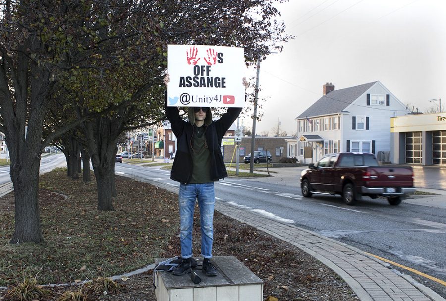 Clayton Redden, a Charleston resident, protests the Julian Assange case Saturday afternoon on Lincoln Ave. outside of Old Main. “I’m trying to bring Republicans and Democrats together, to spread awareness about the persecution and death of independent journalism.” Redden said. “Spread awareness about the slow crucifixion of Julian Assange who has been exposing war crimes.”