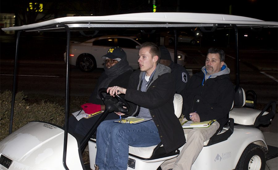 Seth Yeakel, a mathematics major, drives group two in a golf cart during the Safety Walk Monday night outside of Old Main.