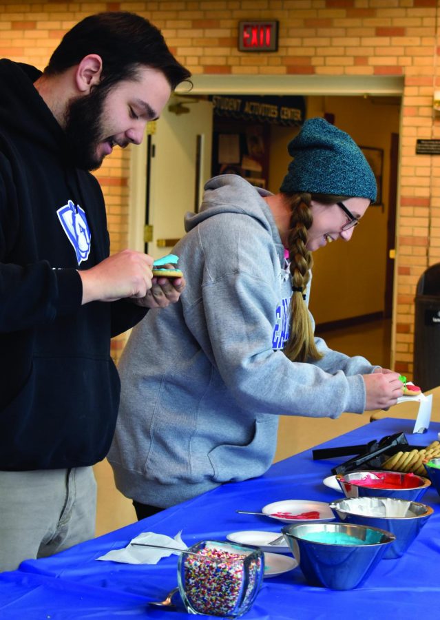 Zac Cohen, the executive vice president of Student Senate, and Rebecca Cash, the student body president, decorate cookies Tuesday afternoon at the Bridge Lounge of the Martin Luther King Jr. University Union.