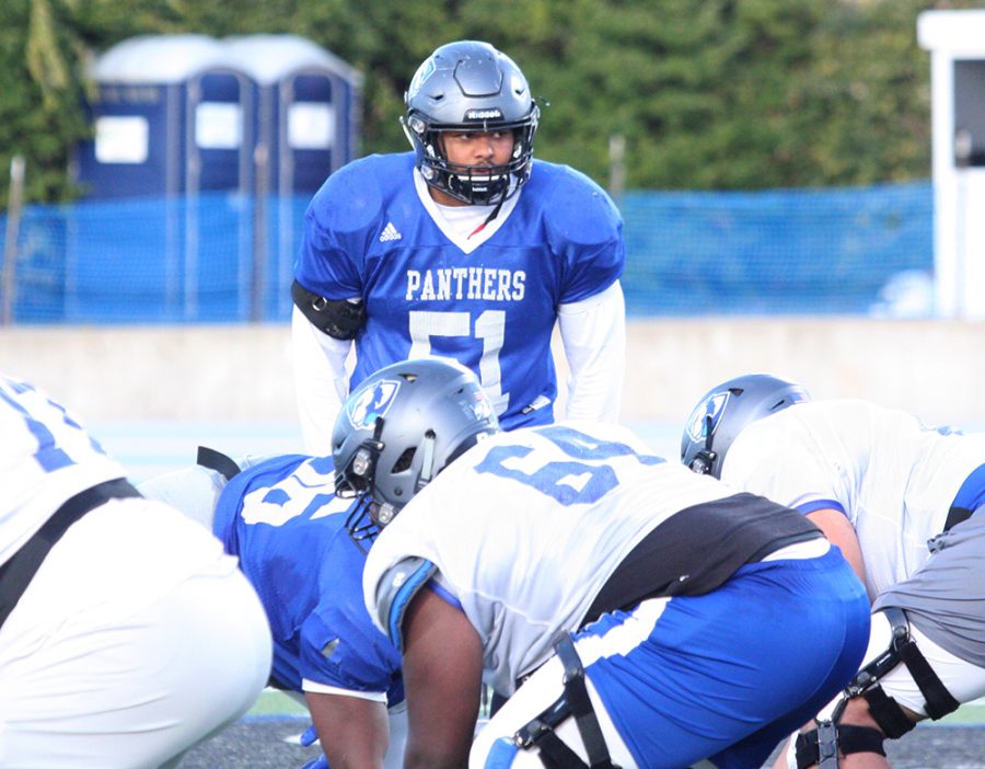 Eastern sophomore linebacker Dytarious Johnson looms over the defensive line as he prepares to defend in a practice at O’Brien Field in October. Johnson is second on the team with 60 tackles and first with 12 tackles for loss.