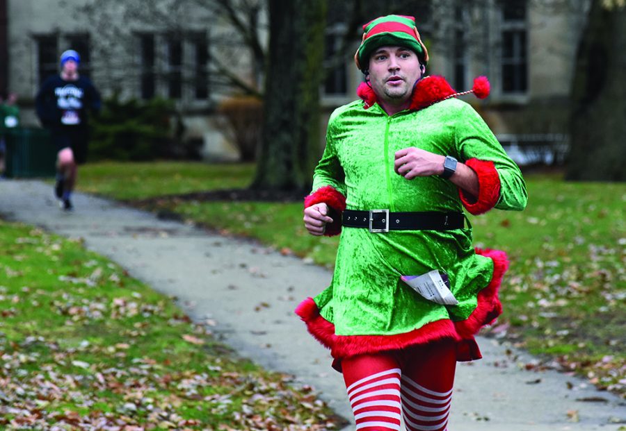 Kaj Holm, a teacher at Charleston High School, wore a Christmas-themed outfit for Saturday’s Holiday Hustle 5K run/walk. He was the fourth person to cross the finish line in front of Old Main with a time of 21 minutes and 55 seconds.