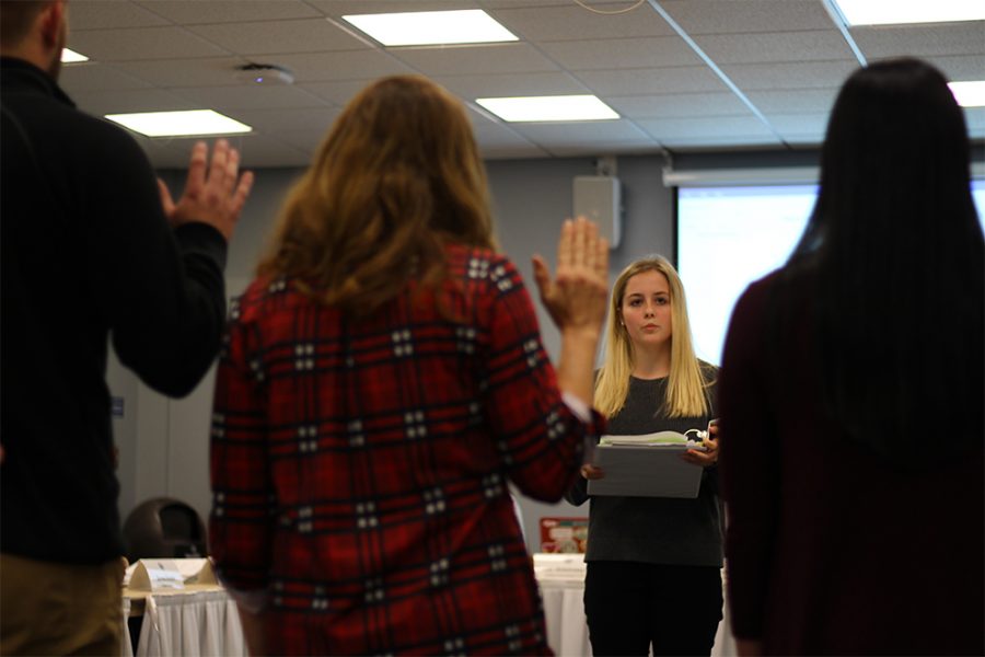 Alicia Matusiak, the Student Vice President of Student Affairs, swears in the new student deans at Wednesday night’s student senate meeting in the Arcola-Tuscola room of the Martin Luther King Jr. University Union.