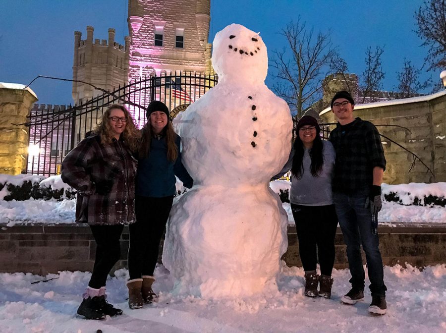 (From left to right) Sophomores Lucy Hill, a music performance major, Resa Fuller, a music performance major, Jessica Stewart, an English education major, and Lucas Lower, a computer science major stand next to a snowman they built Saturday night in front of Old Main. The snowman was knocked down Saturday night.