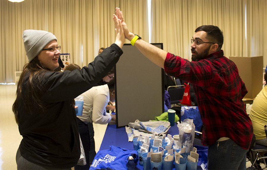 Cassie Mc’Cleery, a family and consumer sciences major, and Ben Mc’Burney, a biology major, high five each other Wednesday afternoon at Pantherpalooza in the University Ballroom.