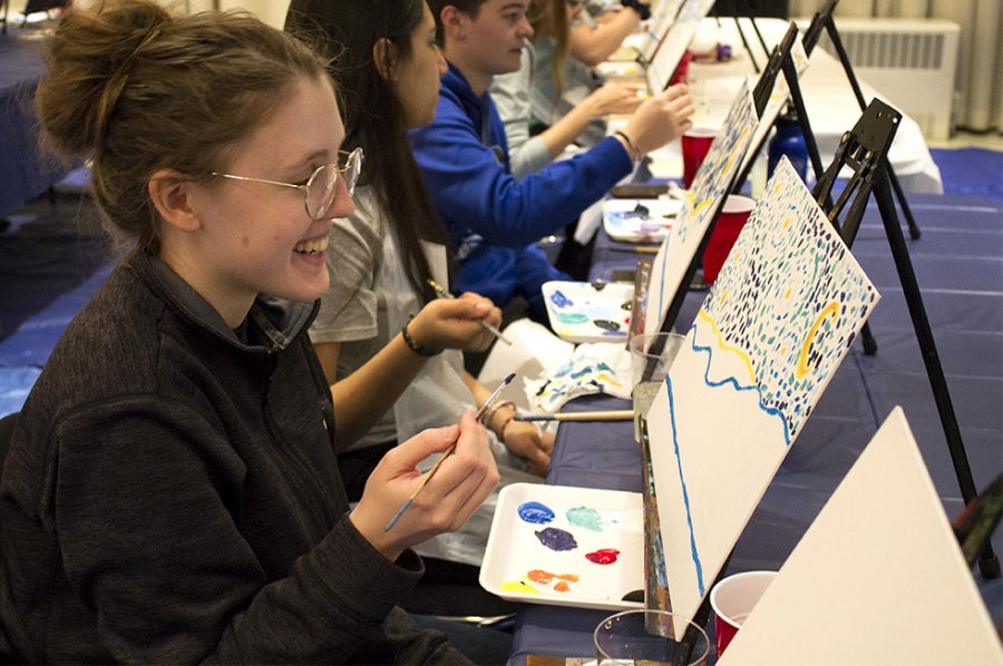 Hannah Lyons, a freshman studio art major, paints during the University Board event, Passport to Fun: France. Several students attended the paint-and-sip that had two two-hour sessions.