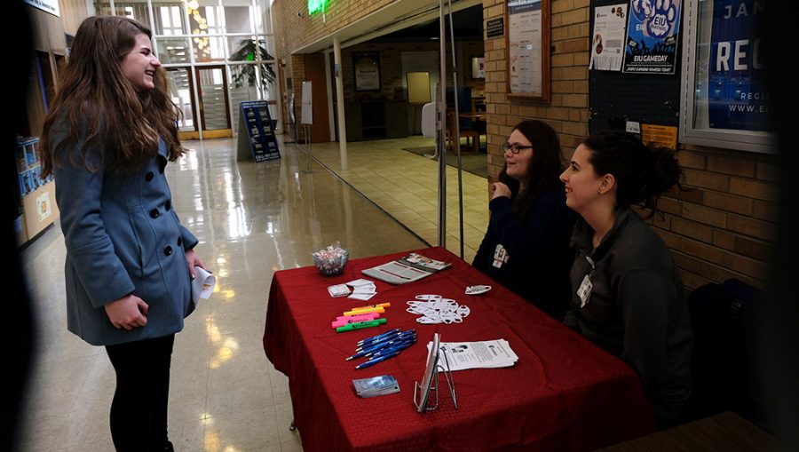 Andrea Carey, a hiring associate, and Rachael Croy, a chief scribe at ScribeAmerica, talk to a student at a table they set up in the Martin Luther King Jr. University Union Thursday afternoon. They were offering employment opportunities as a medical scribe. According to their informational handout, a medical scribe is essentially a personal assistant for a physician; they document and gather information on patient visits.