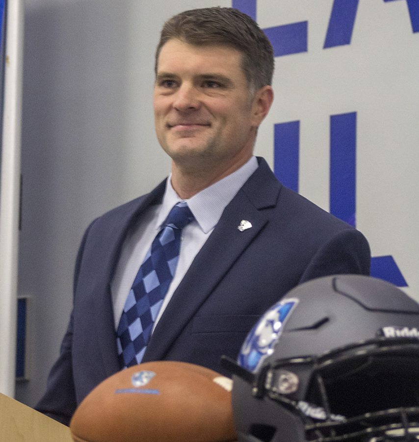 Adam+Cushing%2C+the+new+head+coach+of+the+Eastern+football+team%2C+accepts+applause+after+giving+a+press+conference+in+December+2018.+Cushing+hired+John+Kuceyeski+as+his+offensvie+coordinator.