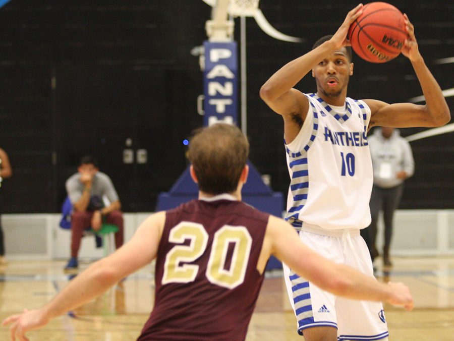 Cam Burrell looks to pass the ball to an open teammate during Eastern’s 79-44 victory over Eureka College in an exhibition match in Lantz Arena Nov. 2.