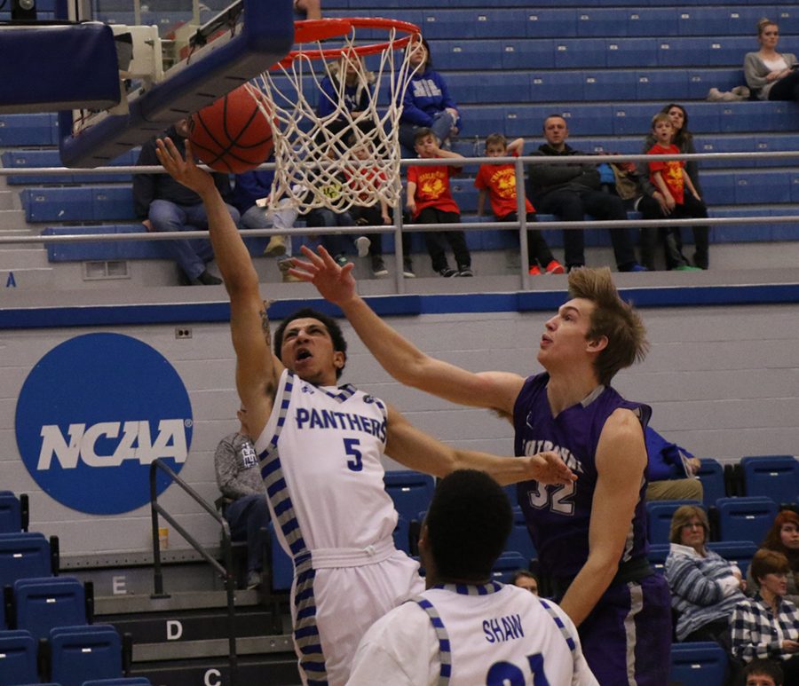 Shareef Smith puts up a layup attempt as a Fontbonne University defender defends him during Eastern’s 90-37 victory over the Griffins on Dec. 4 in Lantz Arena.