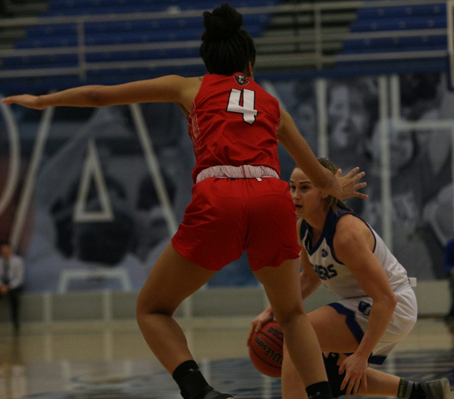 Grace Lennox dribbles the ball between her legs to try to get around a defender during Eastern’s 73-60 loss to Austin Peay Saturday in Lantz Arena.