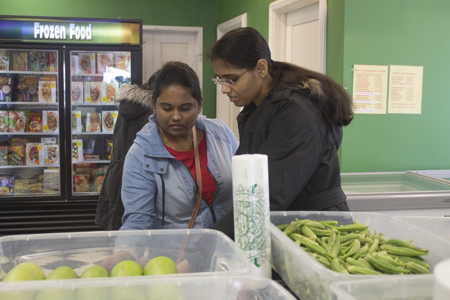 Sushma Saragadam (left), a graduate student in geographic information sciences, and Amulya Boddu (right), a graduate student in computer technology, shop at the Annapoorna store in Champaign on Saturday.