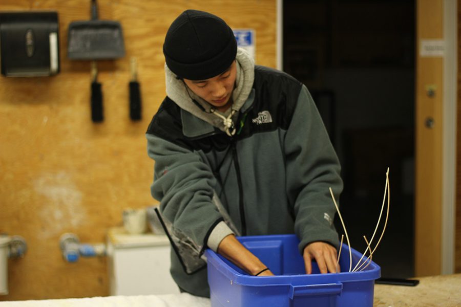 Tsuyoshi Suzuki, a freshman graphic design major, takes on his newest project for his art class: basket weaving. He spends his evening in the Doudna Fine Arts Center working on finishing his basket for tomorrow.