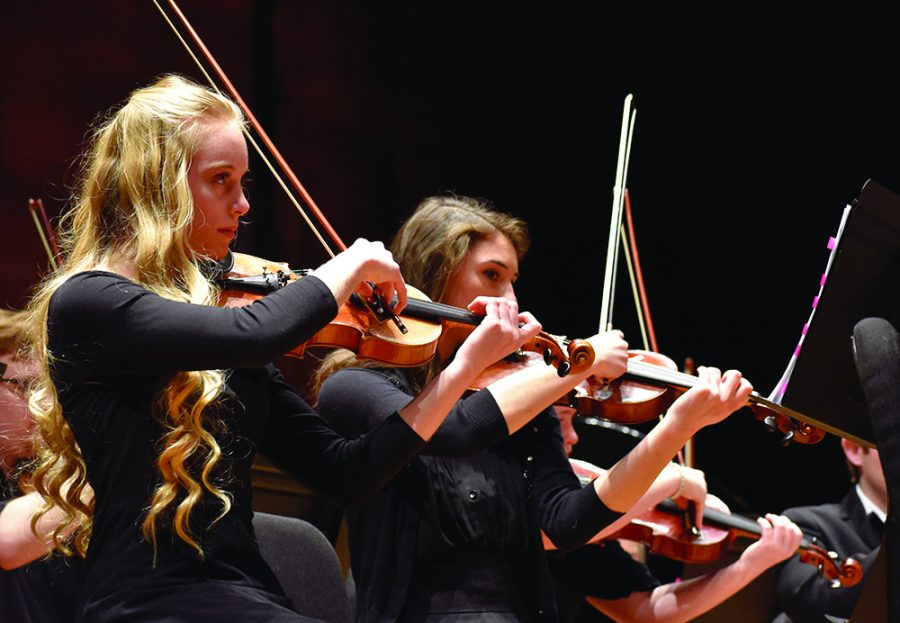 Sadie Armstrong, a member of the Symphonic Honers Initiative Program and pre-college violinist from Mattoon High School, plays violin during the Eastern Symphony Orchestra performance called The American Dream in the Dvorak Concert Hall of the Doudna Fine Arts Center on Sunday afternoon.