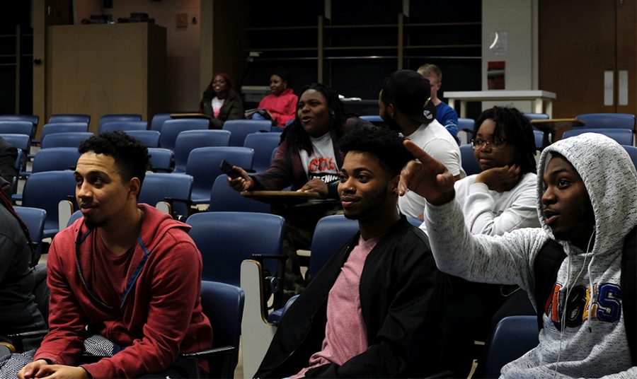 Team Watermelon talks with eachother during the Historical Twist NAACP Jeopardy game Monday night in the Coleman Auditorium.