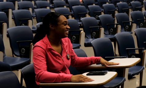 Raven Gant, a pre-medicine major, smiles while playing Jeopardy at the NAACP Historical Twist Monday night in the Coleman Auditorium.