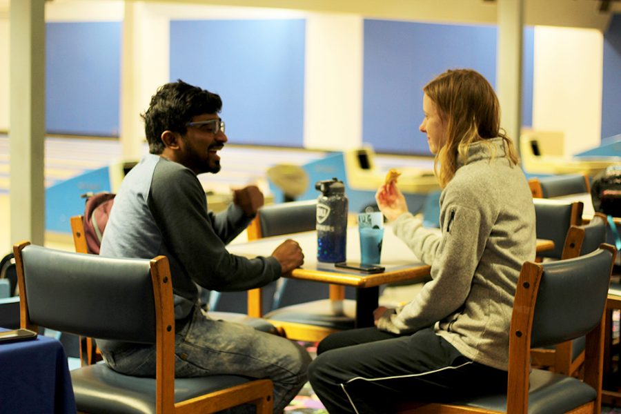 Subha Chandrasekhar, a graduate in technology, and Taylor Powers, a senior in recreation administration, attend the Karaoke Bowling event held by the Univeristy Board in the bowling alley of the Martin Luther King Jr. University Union. The two enjoy pizza provided at the event on Tuesday evening. “I saw it on Facebook and I like bowling, so I thought it would be fun,” Powers said about her interest in the event.