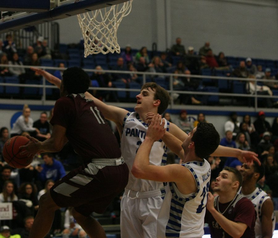 Ben Harvey tries to block an Eastern Kentucky player’s shot attempt during Eastern’s 67-66 win over the Colonels in Lantz Arena Jan. 31.