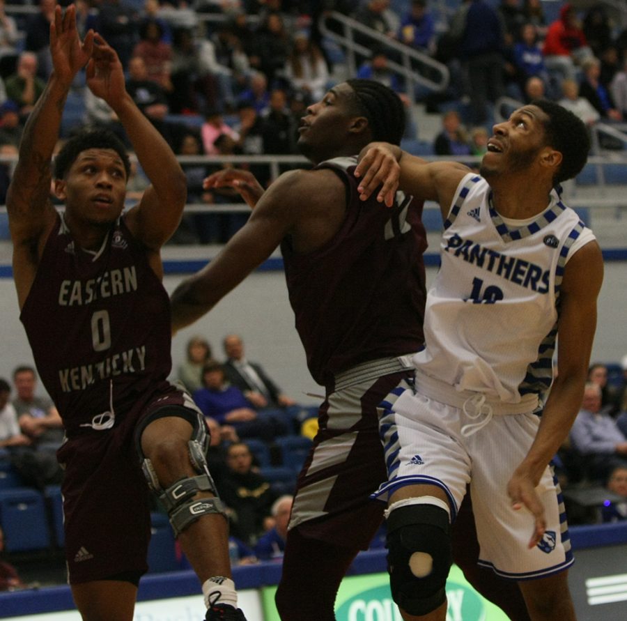 Cam Burrell works against two Eastern Kentucky defenders to fight for an offensive rebound during Eastern’s 67-66 victory in Lantz Arena Jan. 31.