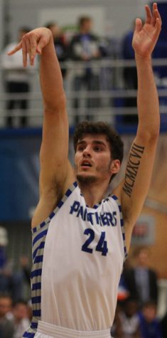 Eastern’s Rade Kukobat shoots a shot in a game for the Panthers this season. His tattoo on his left arm has biblical influences. 