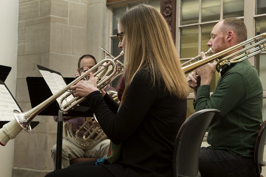 Jenny Brown, a trumpet instuctor, and Will Porter, a trombone instructor, perform one of the five movements from “Celestial Suite” Wednesday afternoon at Booth Library. The five movements each highlight an astronomer or physicist.
